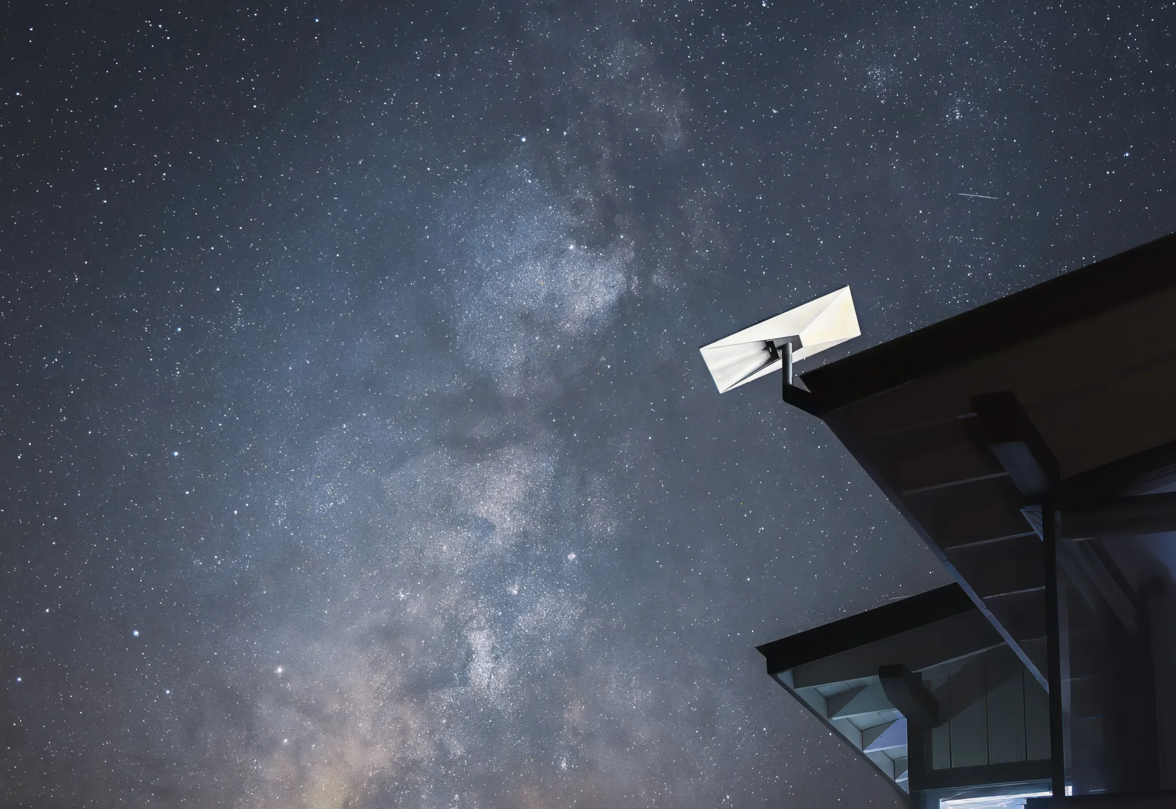 Starlink satellite dish under a starry sky